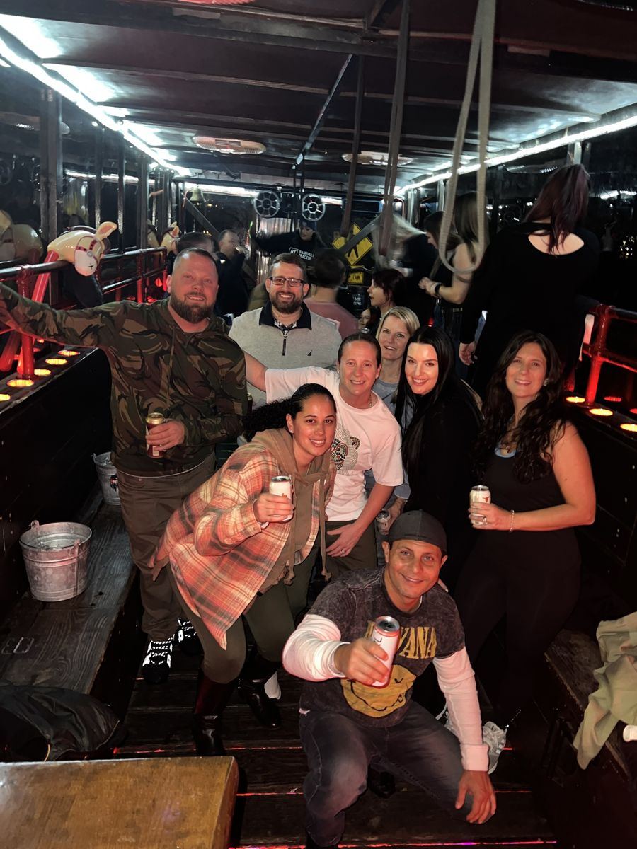Rob and friends raising drinks on a party tractor ride in Nashville